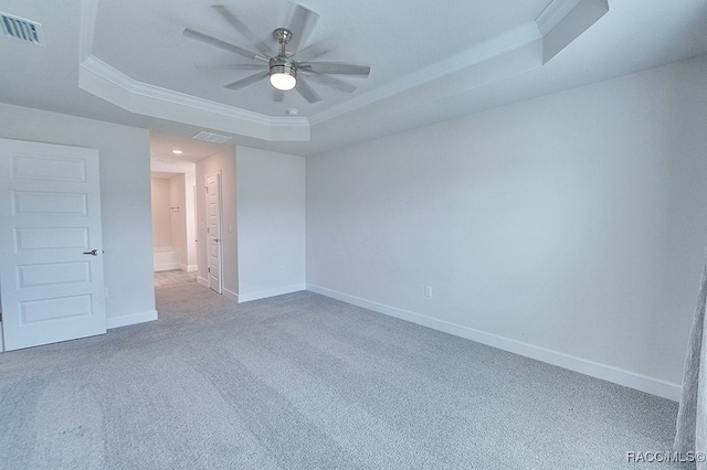 spare room featuring ceiling fan, a raised ceiling, carpet floors, and crown molding