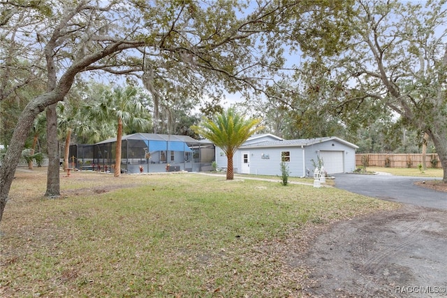 view of yard with a lanai and a garage