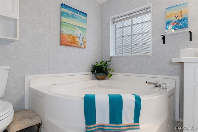 bathroom featuring toilet and a bathing tub