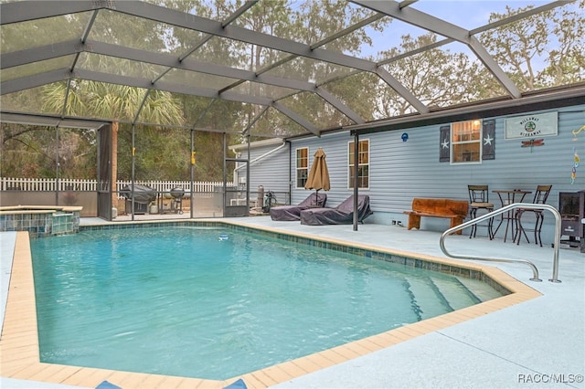 view of swimming pool with a patio, glass enclosure, and an in ground hot tub