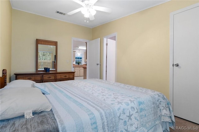 carpeted bedroom featuring ceiling fan and connected bathroom