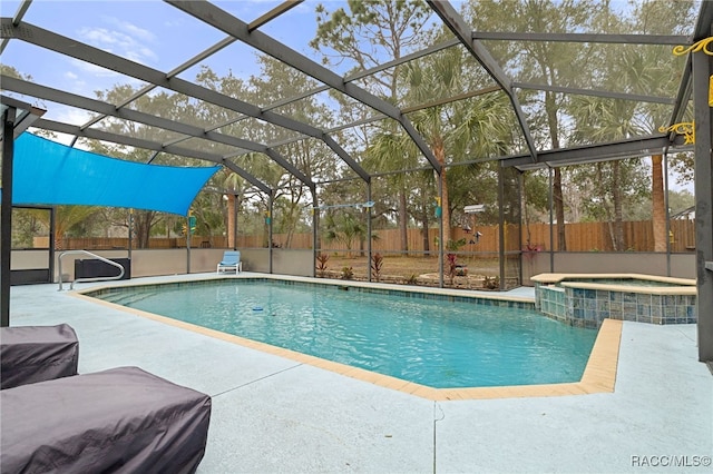 view of swimming pool with an in ground hot tub, glass enclosure, and a patio