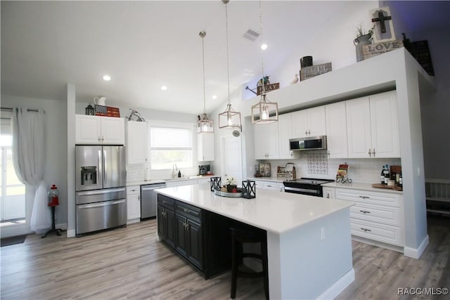 kitchen with light countertops, white cabinets, visible vents, and appliances with stainless steel finishes