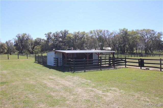 view of stable with a rural view