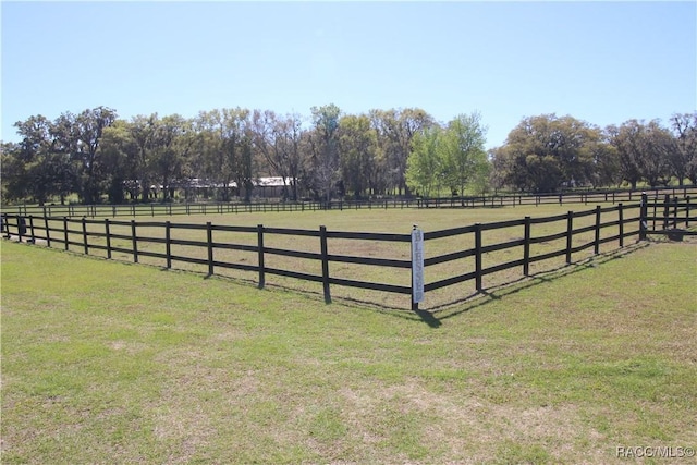 view of yard with a rural view and an enclosed area