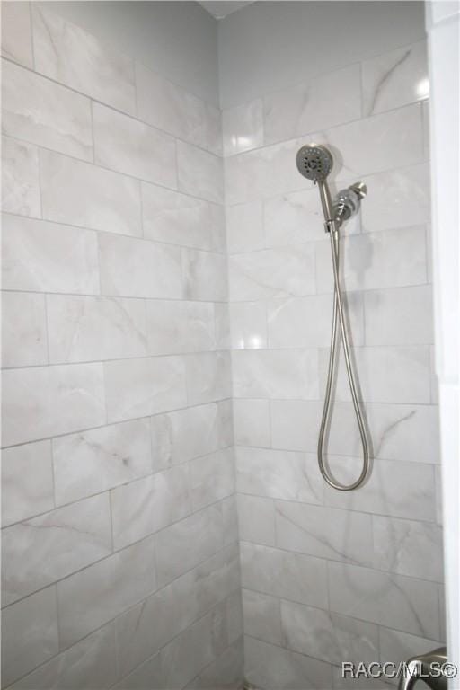 bathroom with tiled shower