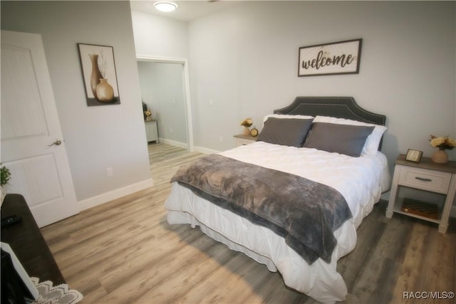 bedroom featuring wood finished floors and baseboards