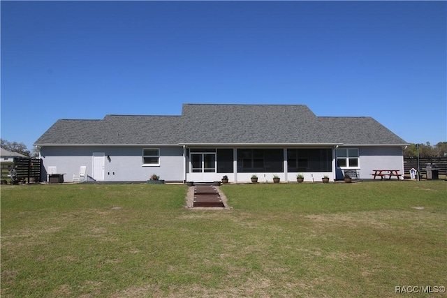 back of property with central air condition unit, a yard, and a sunroom