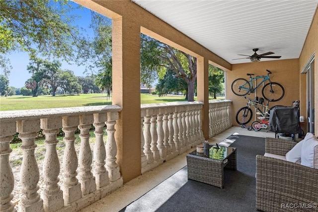 view of patio with ceiling fan and a porch