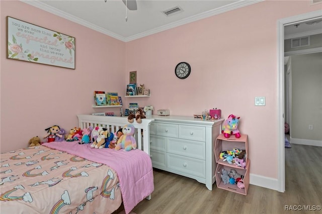 bedroom with crown molding, ceiling fan, and light hardwood / wood-style flooring