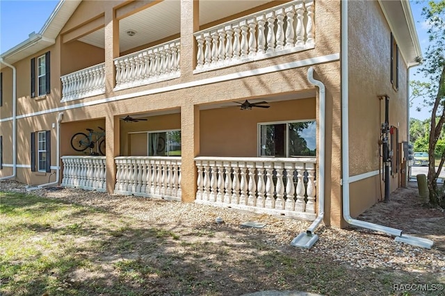 view of property exterior featuring a balcony and ceiling fan