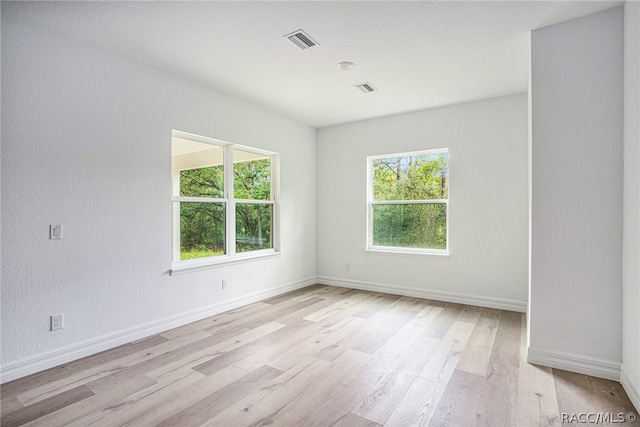 unfurnished room with light wood-type flooring