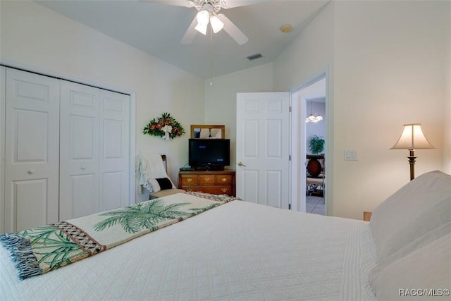 bedroom with ceiling fan, vaulted ceiling, and a closet