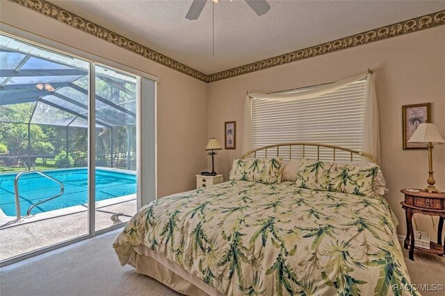 carpeted bedroom featuring access to outside, a textured ceiling, and ceiling fan