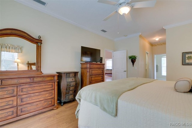 bedroom with ornamental molding, ceiling fan, and light hardwood / wood-style floors