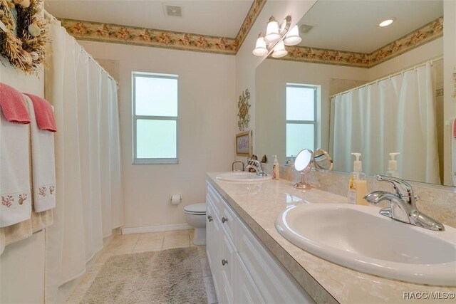 bathroom with vanity, tile patterned floors, and toilet