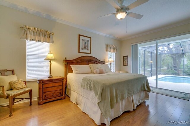 bedroom featuring ceiling fan, ornamental molding, access to exterior, and multiple windows