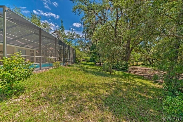 view of yard featuring glass enclosure