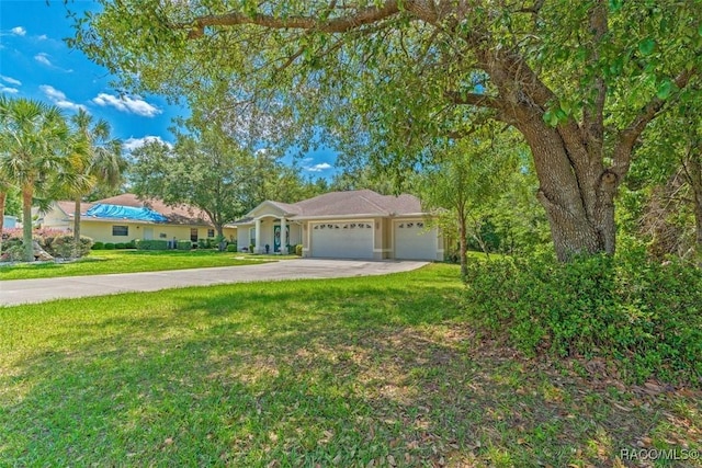 single story home with a garage and a front lawn