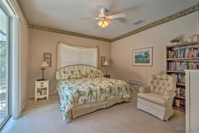 bedroom with ceiling fan, a textured ceiling, carpet, and access to outside