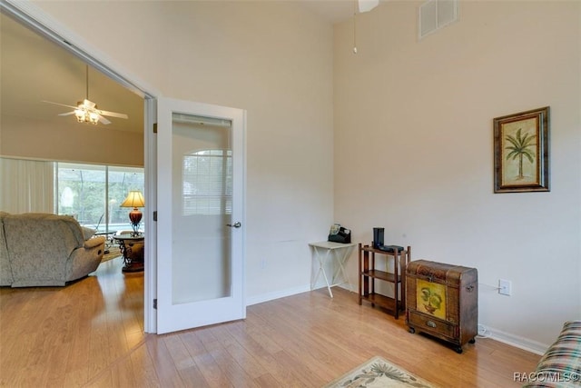 sitting room featuring ceiling fan and light wood-type flooring