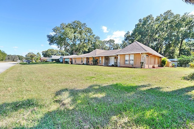 ranch-style house with a front lawn