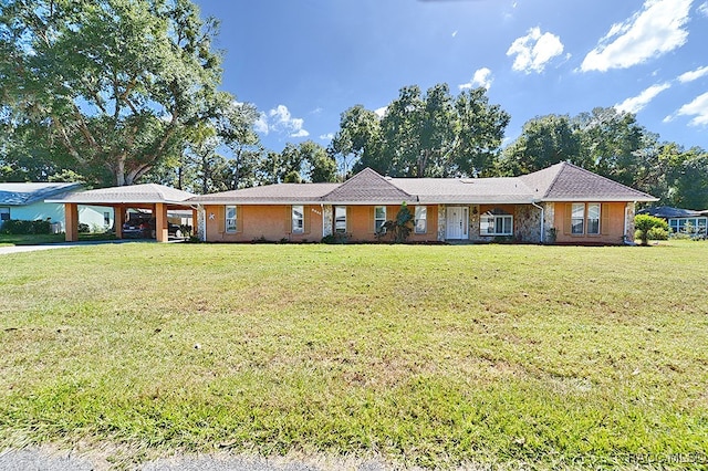 single story home with a front lawn and a carport