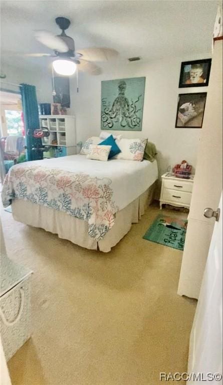 bedroom with ceiling fan and carpet floors