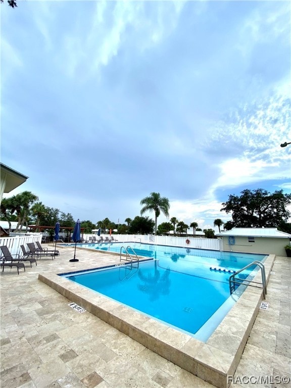 view of swimming pool featuring a patio area