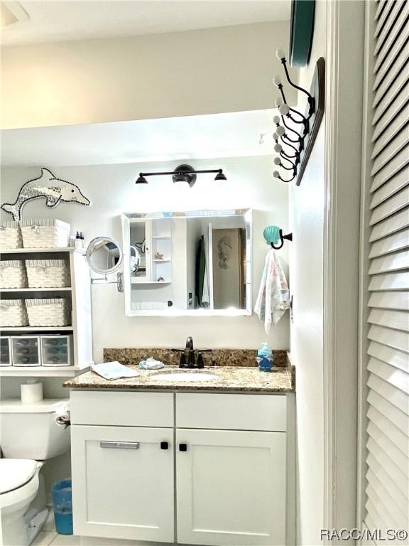 bathroom featuring toilet and vanity