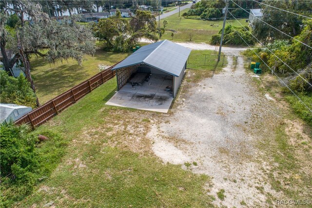 entry to storm shelter with a yard and an outdoor structure