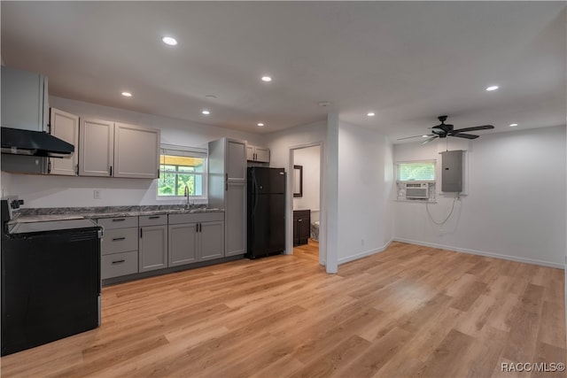 kitchen featuring gray cabinetry, electric panel, black appliances, ceiling fan, and light wood-type flooring