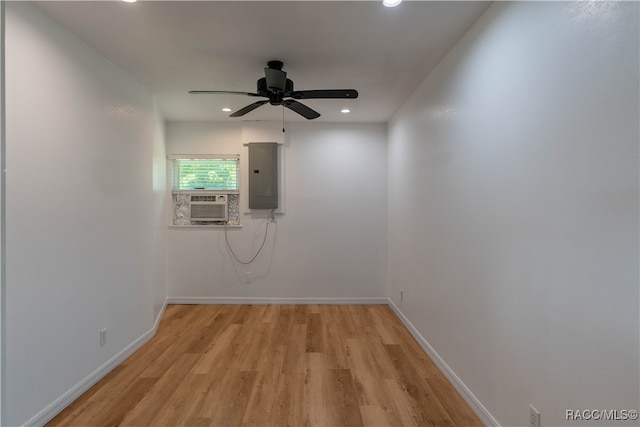 spare room featuring ceiling fan, light hardwood / wood-style floors, and electric panel