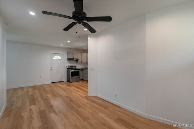 unfurnished living room with ceiling fan and light hardwood / wood-style floors