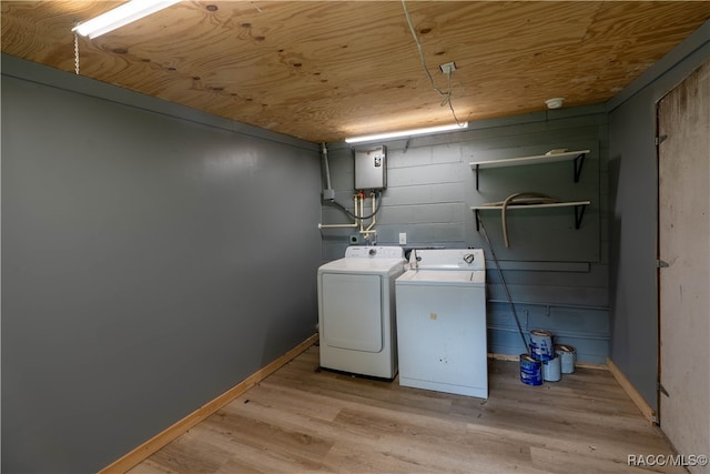 laundry room with wooden ceiling, light hardwood / wood-style flooring, water heater, and washing machine and clothes dryer