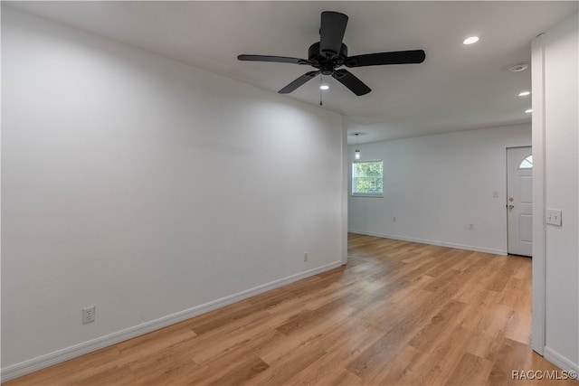 empty room featuring ceiling fan and light wood-type flooring