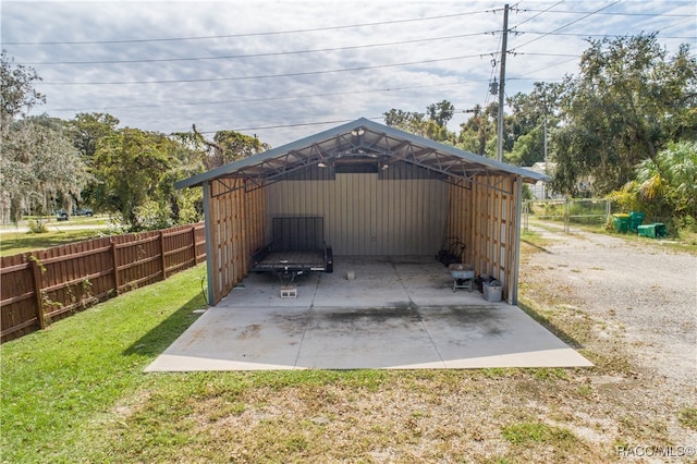 view of parking / parking lot featuring a carport and a yard