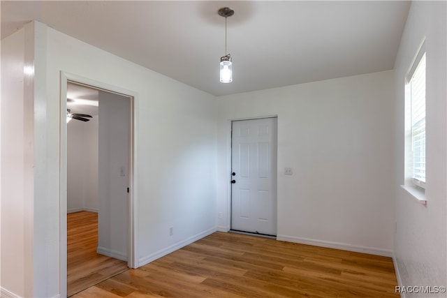 empty room with hardwood / wood-style floors and ceiling fan