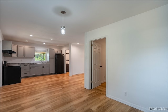 kitchen with gray cabinetry, sink, light hardwood / wood-style floors, decorative light fixtures, and black appliances