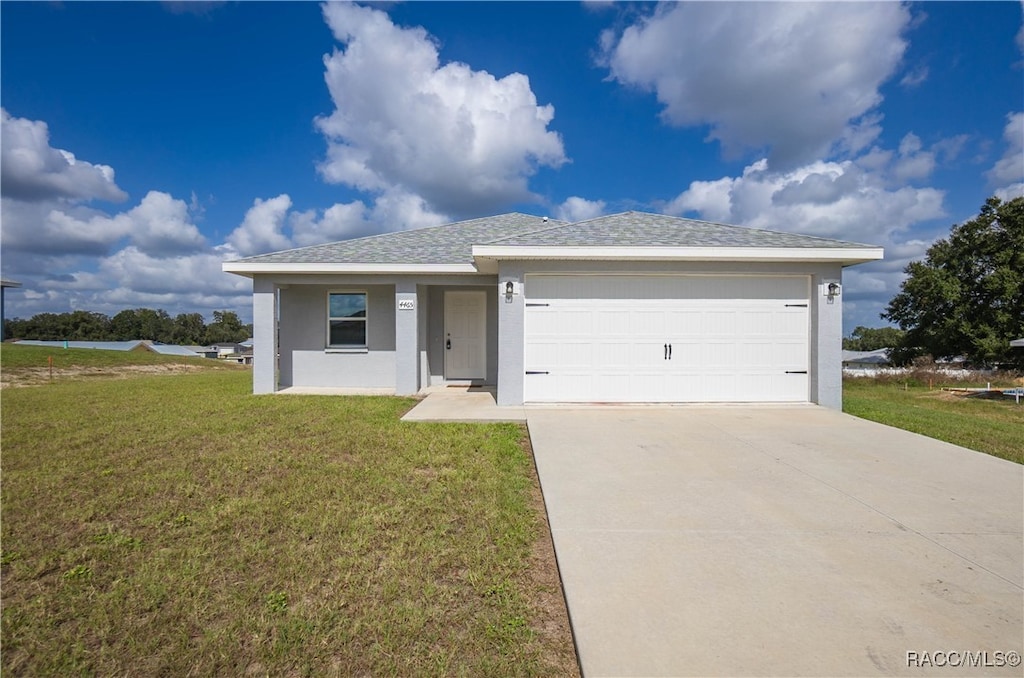 view of front of home featuring a front yard and a garage