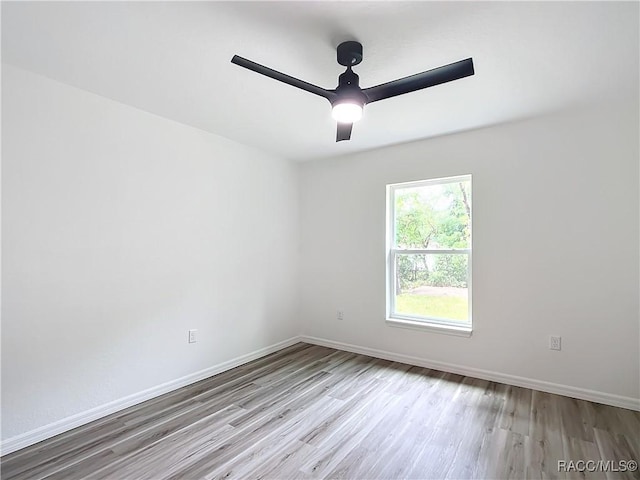 spare room featuring ceiling fan and light hardwood / wood-style floors