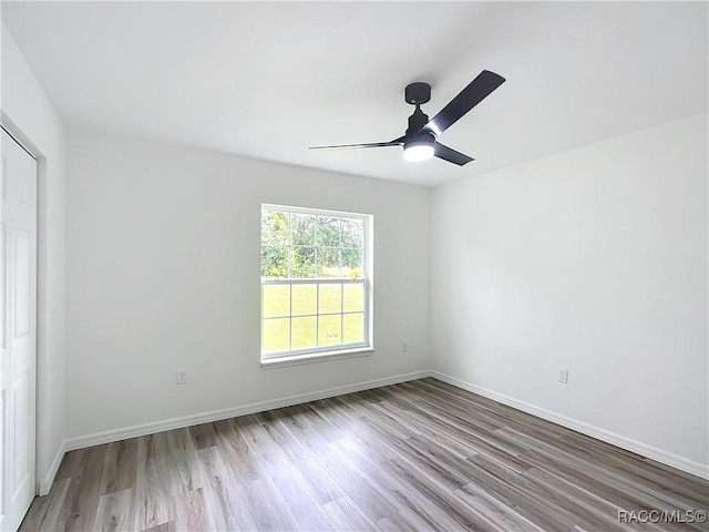 spare room featuring light hardwood / wood-style floors and ceiling fan