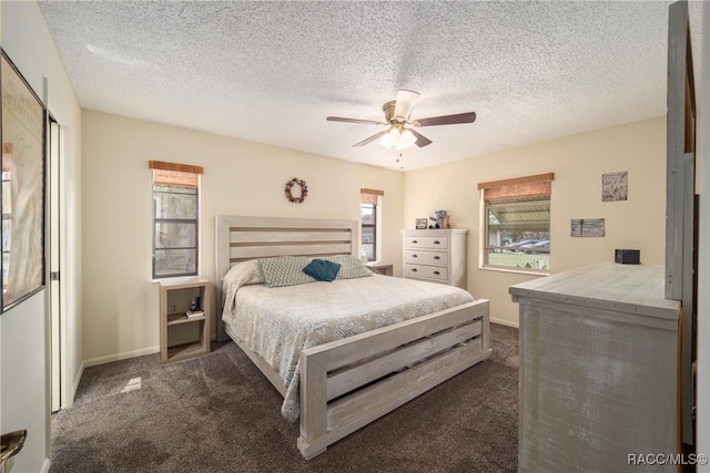 bedroom featuring a textured ceiling, a ceiling fan, dark carpet, and baseboards