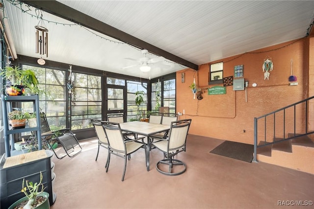 sunroom / solarium with outdoor dining space, beamed ceiling, and a ceiling fan
