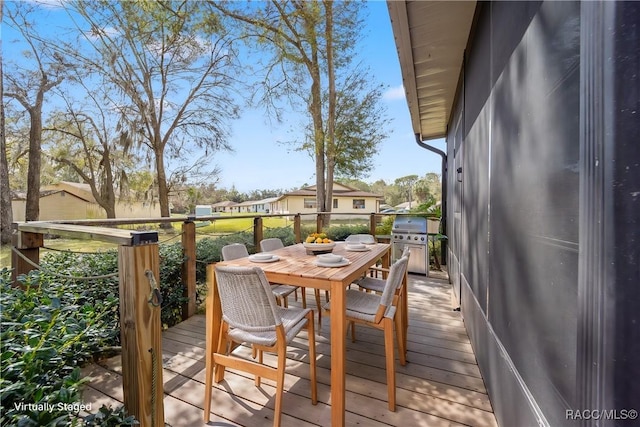 wooden deck featuring outdoor dining area and area for grilling
