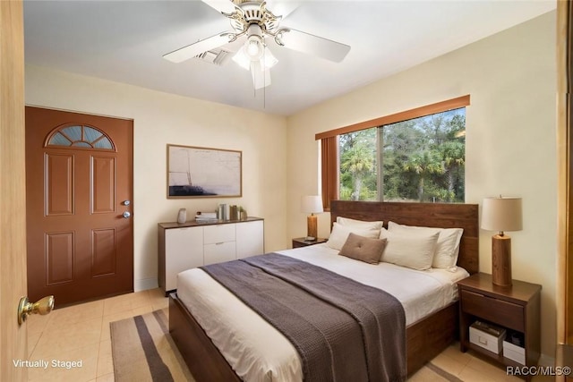bedroom with light tile patterned flooring, a ceiling fan, and visible vents