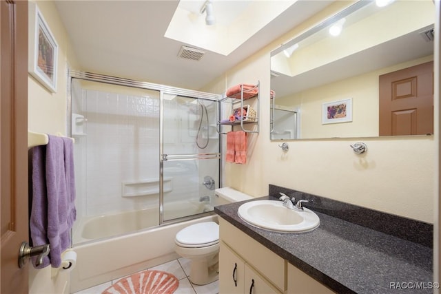 bathroom featuring a skylight, tile patterned floors, toilet, vanity, and visible vents