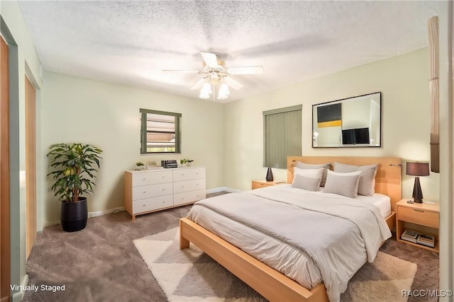 carpeted bedroom with a textured ceiling, ceiling fan, and baseboards