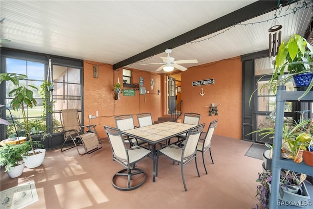 sunroom / solarium featuring beamed ceiling