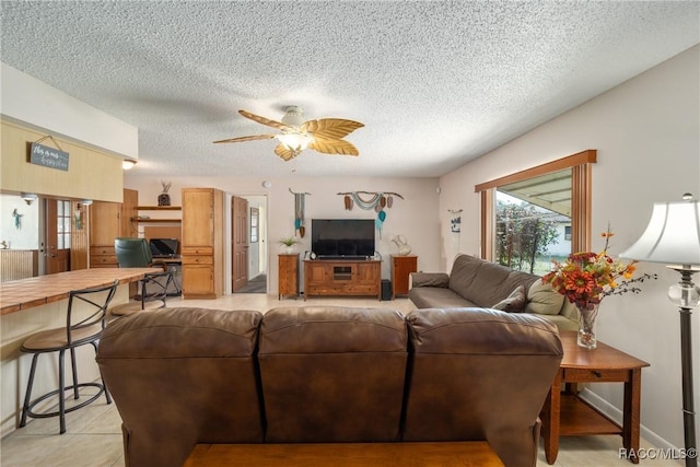 living room featuring a textured ceiling and a ceiling fan